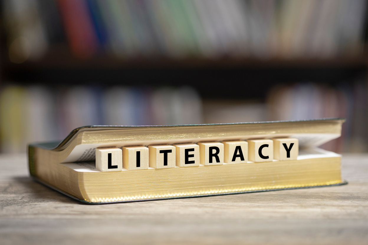 Book on desk with Literacy word