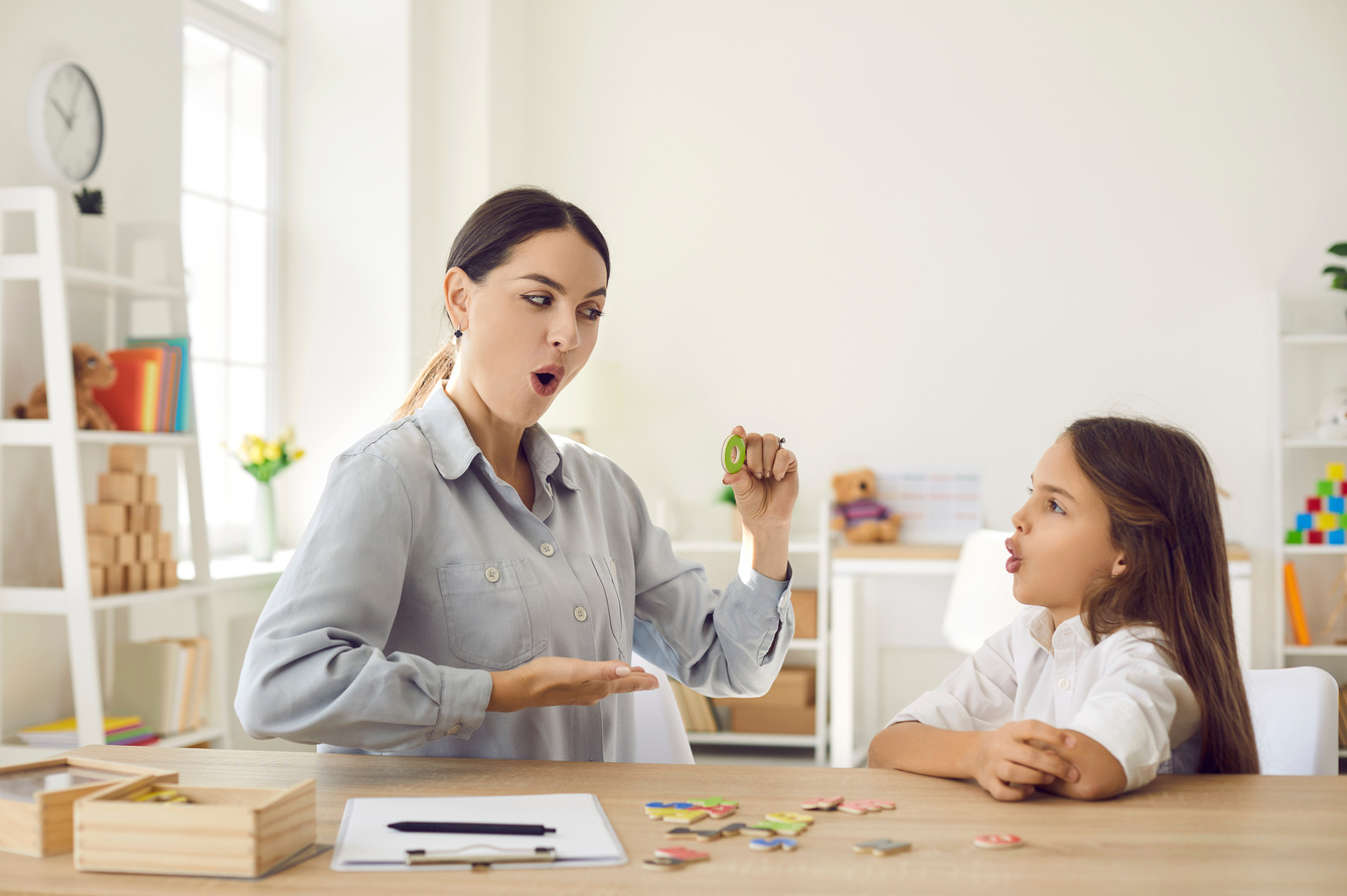 Child Learning Letters and Doing Articulation Exercise Together with Speech Therapist